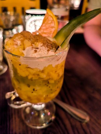 Mein Nachtisch: tropische Früchte als ein Cocktail mit Sahne